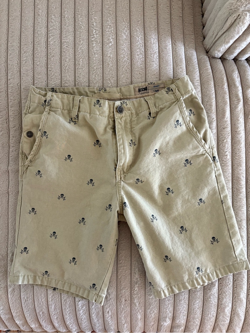 CHANEL Khaki Flat-Front Shorts with Black Skull Print
